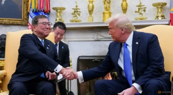 two men shaking hands in a room