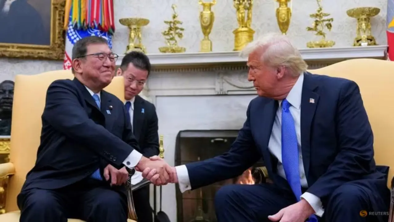 two men shaking hands in a room